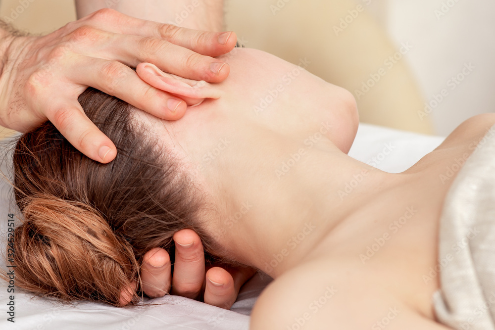Male's hands doing head massage for young woman, close up. Male's hands doing head massage for young woman, close up.