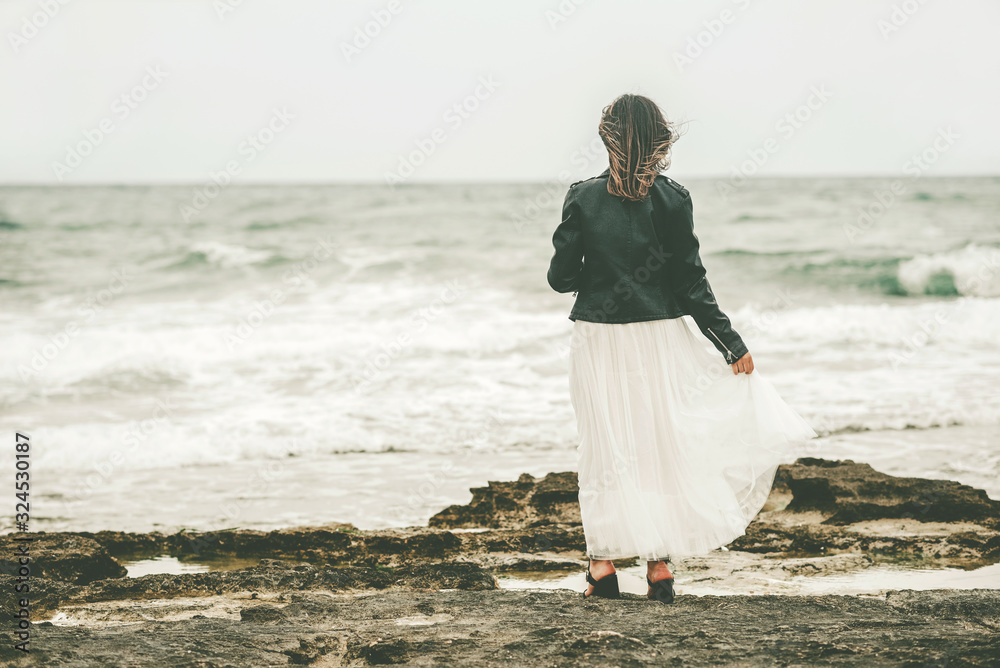 Back view of Pensive Young woman on the beach Back view of Pensive Young woman on the beach