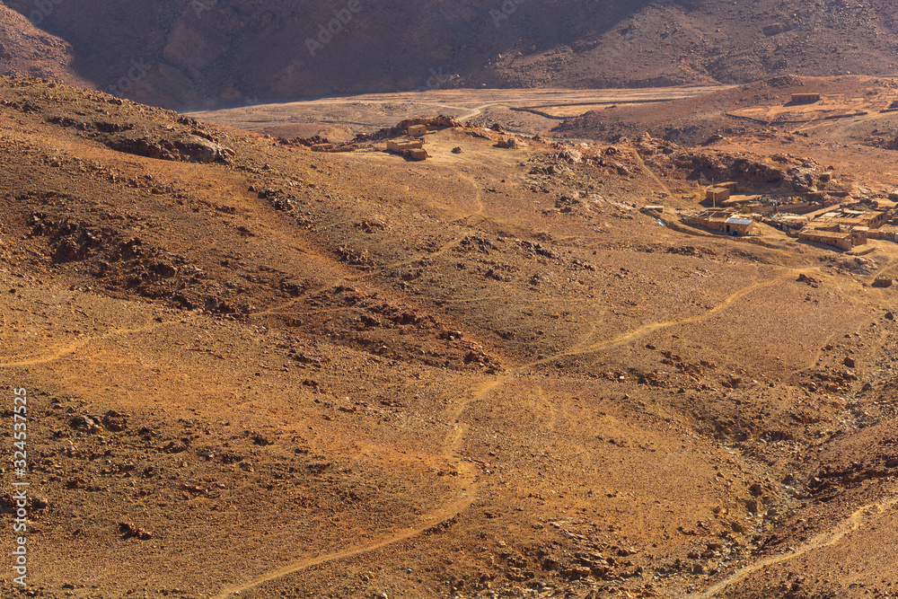 Fototapeta premium Egypt. Bedouin village. Mount Sinai in the morning in the bright sun. (Mount Horeb, Gabal Musa, Moses Mount). Pilgrimage place and famous touristic destination.