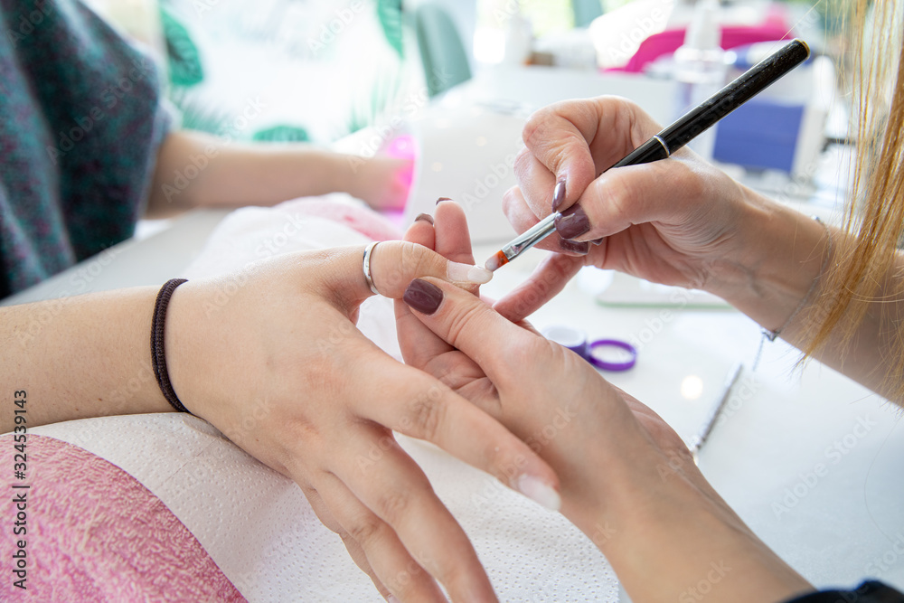 Manicure process in beauty salon - woman hand nails care. Manicure process in beauty salon - woman hand nails care.