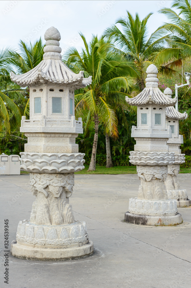Street lamps carved from stones on the territory of Buddhist center Nanshan.