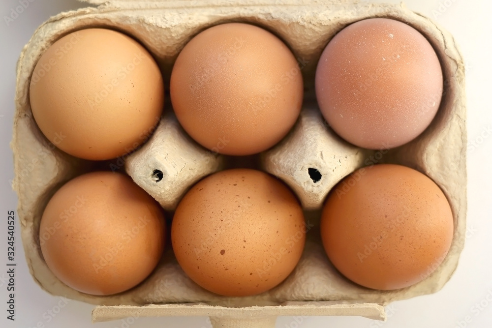 Pack of six free range eggs on white background. Top view. Pack of six free range eggs on white background. Top view.
