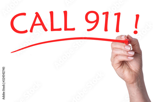 Hand writes word call 911 with red marker photo