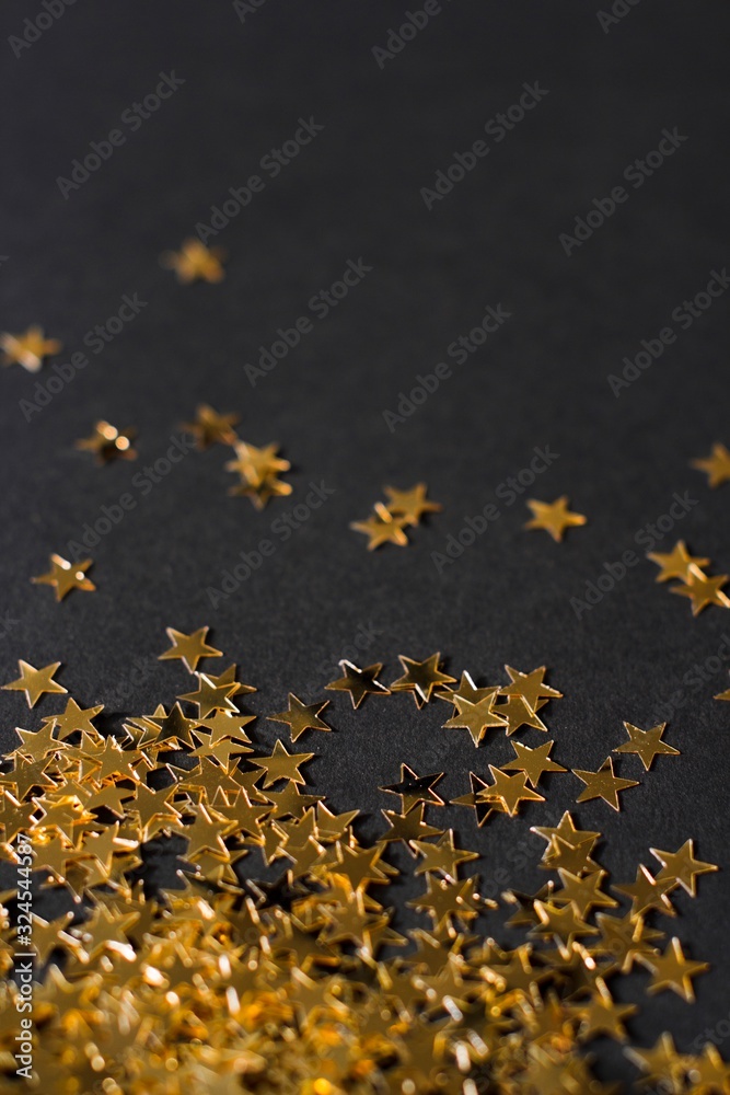 gold sparkly glitter stars on black background gold sparkly glitter stars on black background