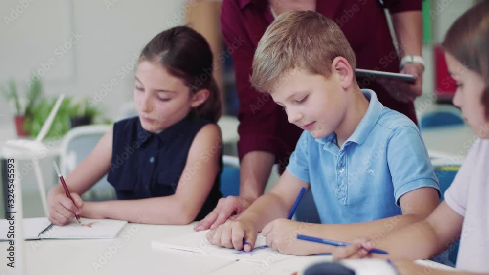 Group of small school kids in class, drawing. Group of small school kids in class, drawing.