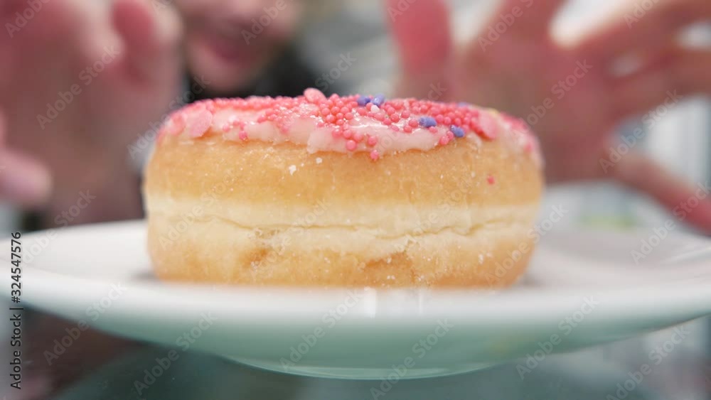 Man opening the fridge door and picking up a colorful cake to eat as a snack. The camera placed inside the refrigerator. Man opening the fridge door and picking up a colorful cake to eat as a snack. The camera placed inside the refrigerator.