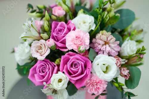 Bouquet of bright fresh flowers in a pink pot