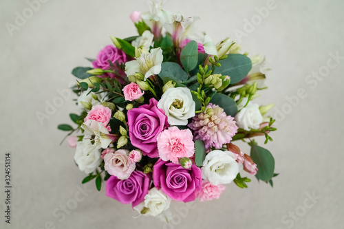 Bouquet of bright fresh flowers in a pink pot