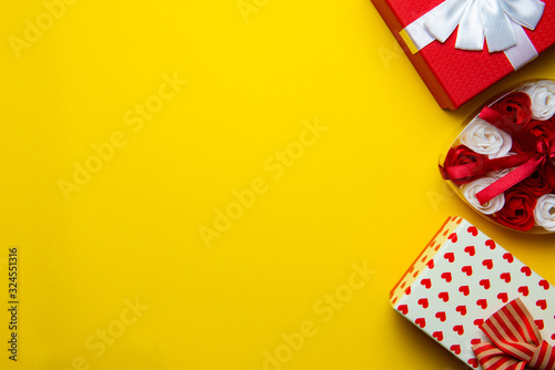 Red gift boxes on a yellow background.Flat lay,copy space