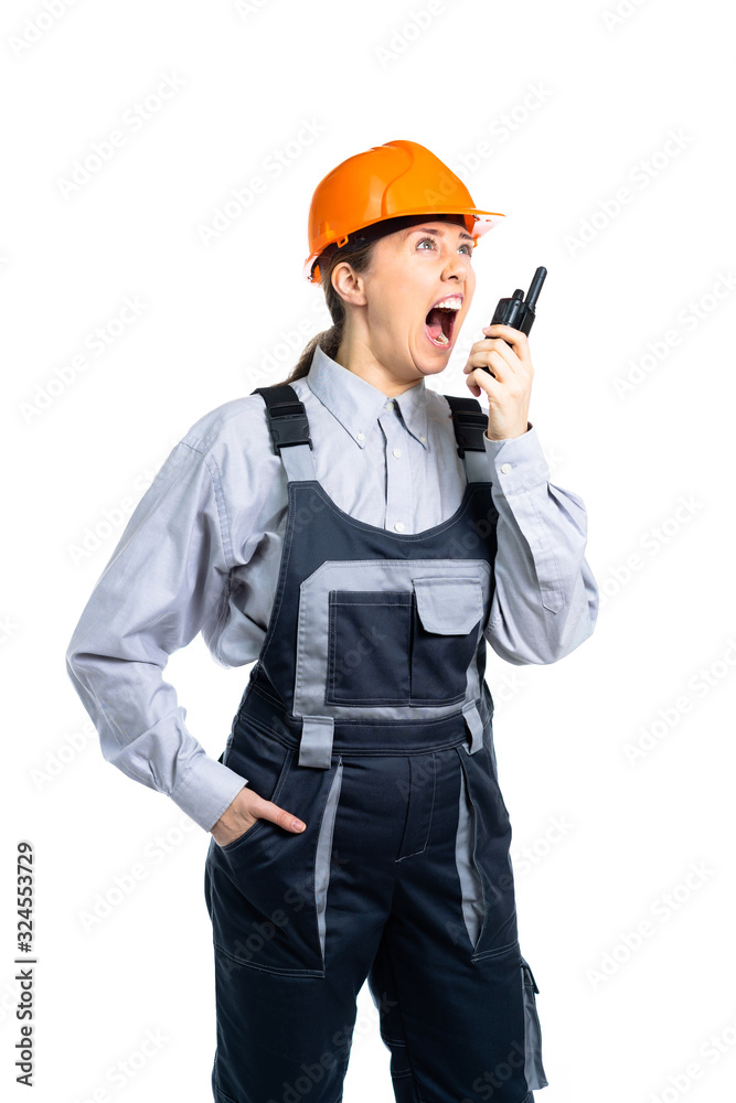 woman civil engineer swears on the walkie-talkie with the workers. Isolated woman civil engineer swears on the walkie-talkie with the workers. Isolated