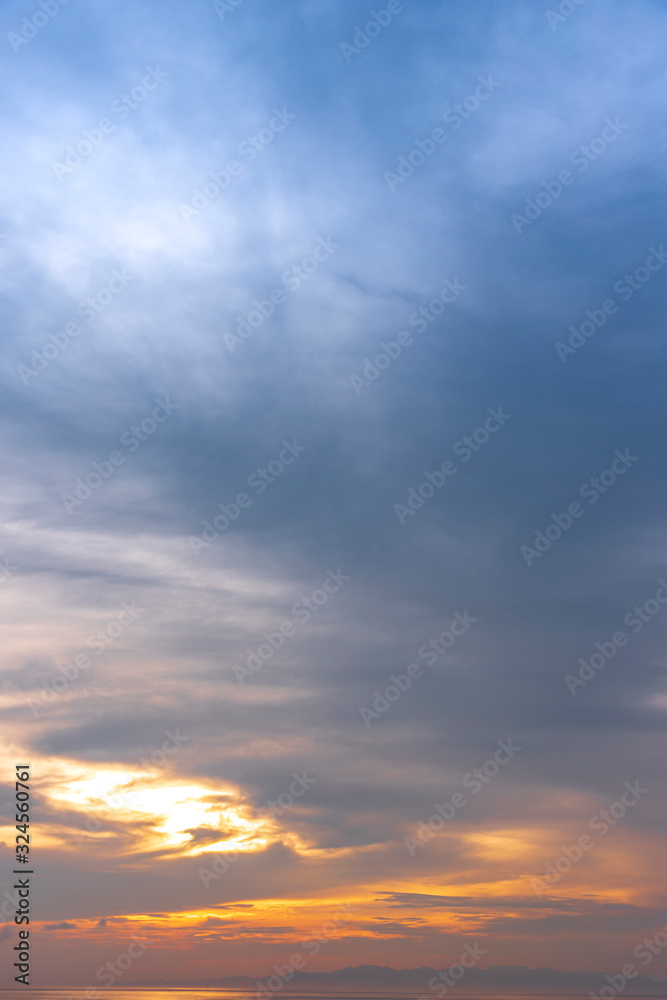 Fototapeta premium sunset / sun rise sky with rays of yellow and red light shining clouds and sky background and texture