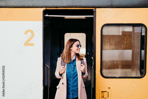 happy young woman at train station. Travel concept