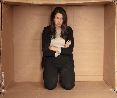 unhappy unemployed business woman trying to increase her cramped office
