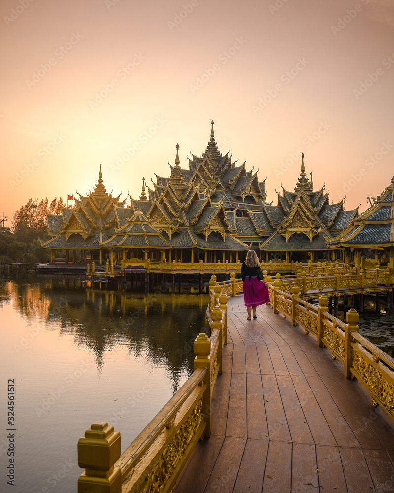 Naklejka premium Amazing sunset on temple in Thailand with tourist girl - Ancien Siam in Bangkok 