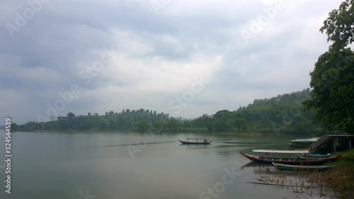 fishermen with small prah crossing the lake photo