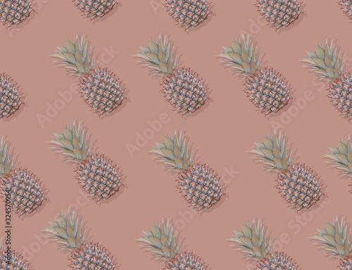 Fototapeta Naklejka Na Ścianę i Meble -  Pattern with pineapples on pastel background. Colorful fruit pattern of fresh pineapples on pink pastel background. Top view on pineapples.