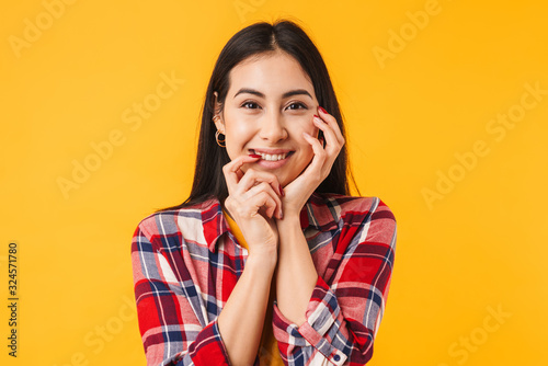 Photo of happy brunette woman smiling while looking at camera