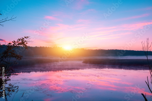Sunrise over the lake in early spring. Serene lake in the morning. Nature landscape © vvvita