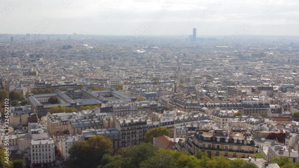 Pan view of Parisian roofs from above with the Eiffel tower and Paris La Defense, viewed from Montmartre Sacred Heart Basilica Pan view of Parisian roofs from above with the Eiffel tower and Paris La Defense, viewed from Montmartre Sacred Heart Basilica