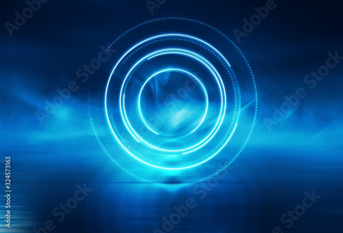 Dark blue abstract futuristic background. Laser geometric figure of a cyber circle in the center of the stage. Neon light, reflection on the asphalt, smoke, smog