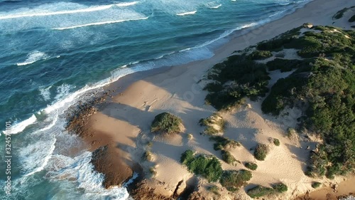 Aerial of Sandy Shore in Tofo Mozambique with Crashing Waves photo