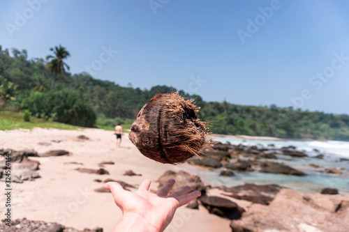 coconut hovering above a hand