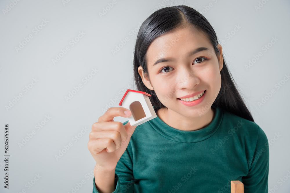 Young asian business woman with small house, grow up business solutions and protection concept. Young asian business woman with small house, grow up business solutions and protection concept.