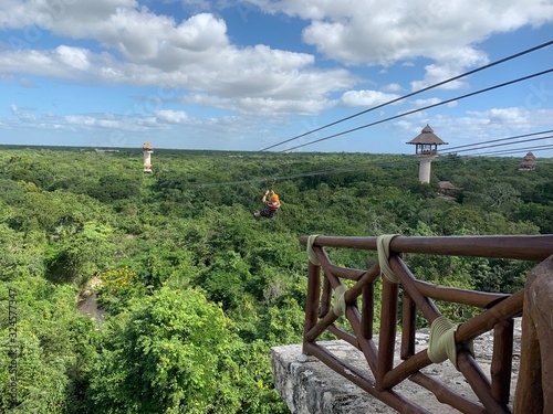 Adventure park in Mexico. Zip line platform. Lush jungles are around. 