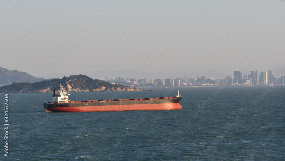 Cargo ship, bulk-carrier, sailing near the Chinese coast. Cargo ship, bulk-carrier, sailing near the Chinese coast.