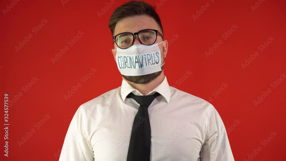 A man in office clothes is wearing a protective medical mask. Coronavirus 2019-nCov is a new concept of coronavirus responsible for the outbreak of Asian flu and coronavirus flu. A man in office clothes is wearing a protective medical mask. Coronavirus 2019-nCov is a new concept of coronavirus responsible for the outbreak of Asian flu and coronavirus flu.