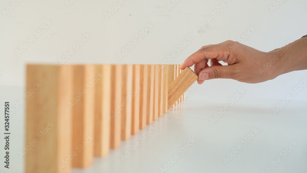 Businessman hand is placing the wooden pieces. Business development concept