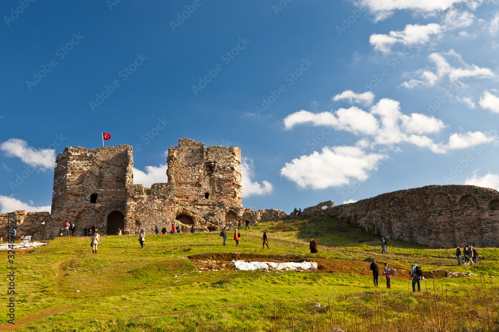Tourists walk near the fortress of Yoros (Genoese fortress). January 2, 2012, Anadolu, Turkey
