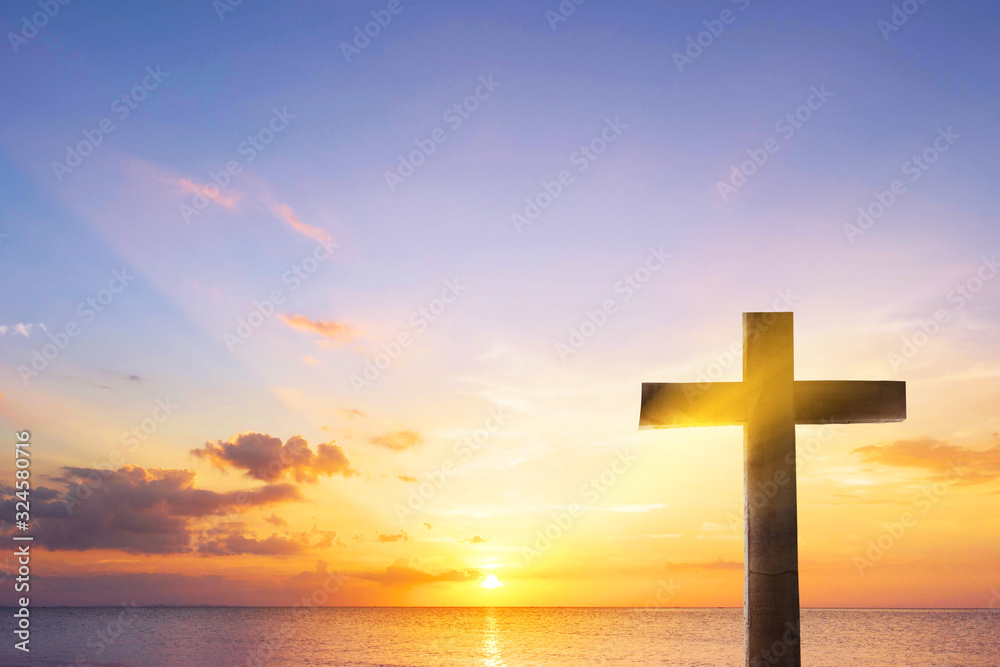 Silhouette cross on  sunset background