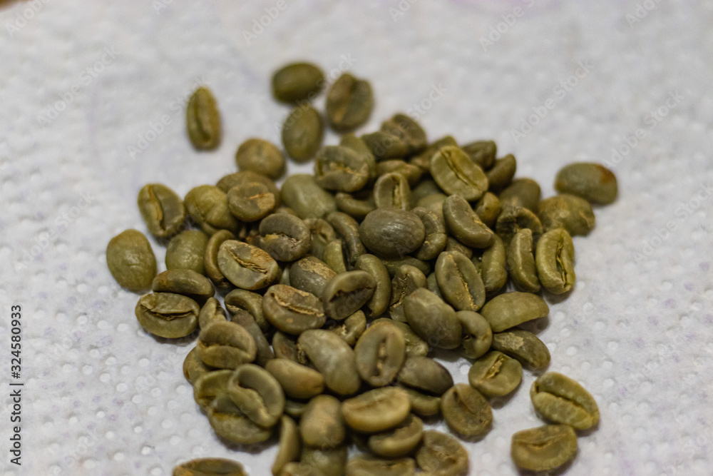 Obraz premium green coffee beans on white background close up