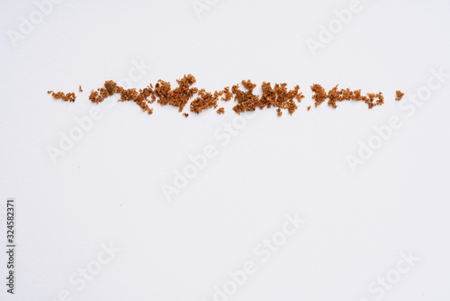 Muscovado sugar isolated on a white background. Abstract pattern. Top view