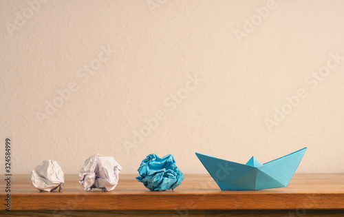 New ideas or teamwork concept with crumpled paper and paper boat