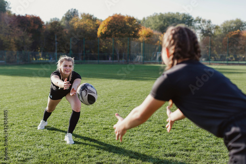 Blonde girl throwing a ball to a team mate