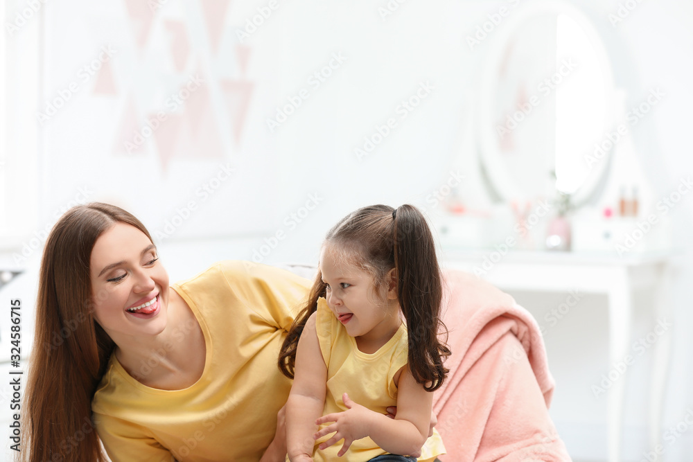 Young mother with little daughter having fun at home Young mother with little daughter having fun at home