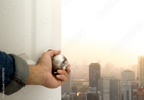 Hand open the door to find city view.Explorer for opportunity and successful concept.