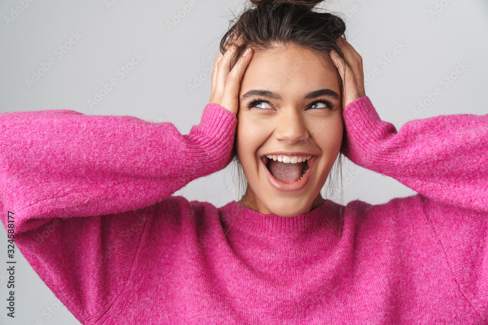 Image of nice excited woman smiling and grabbing her head Image of nice excited woman smiling and grabbing her head