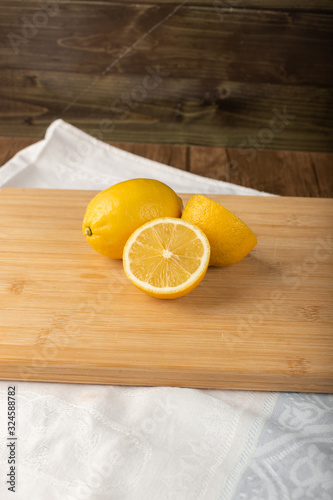 Fresh juicey lemons on a wooden board photo