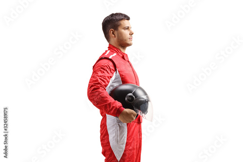 Racer in a red jumpsuit standing and holding a halmet