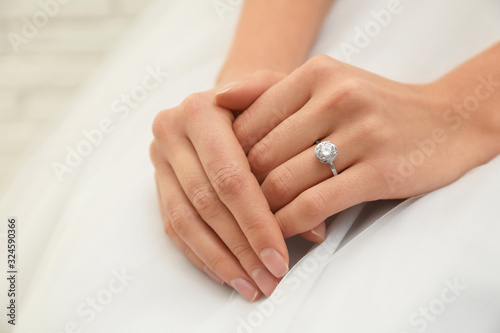 Young bride wearing beautiful engagement ring  closeup