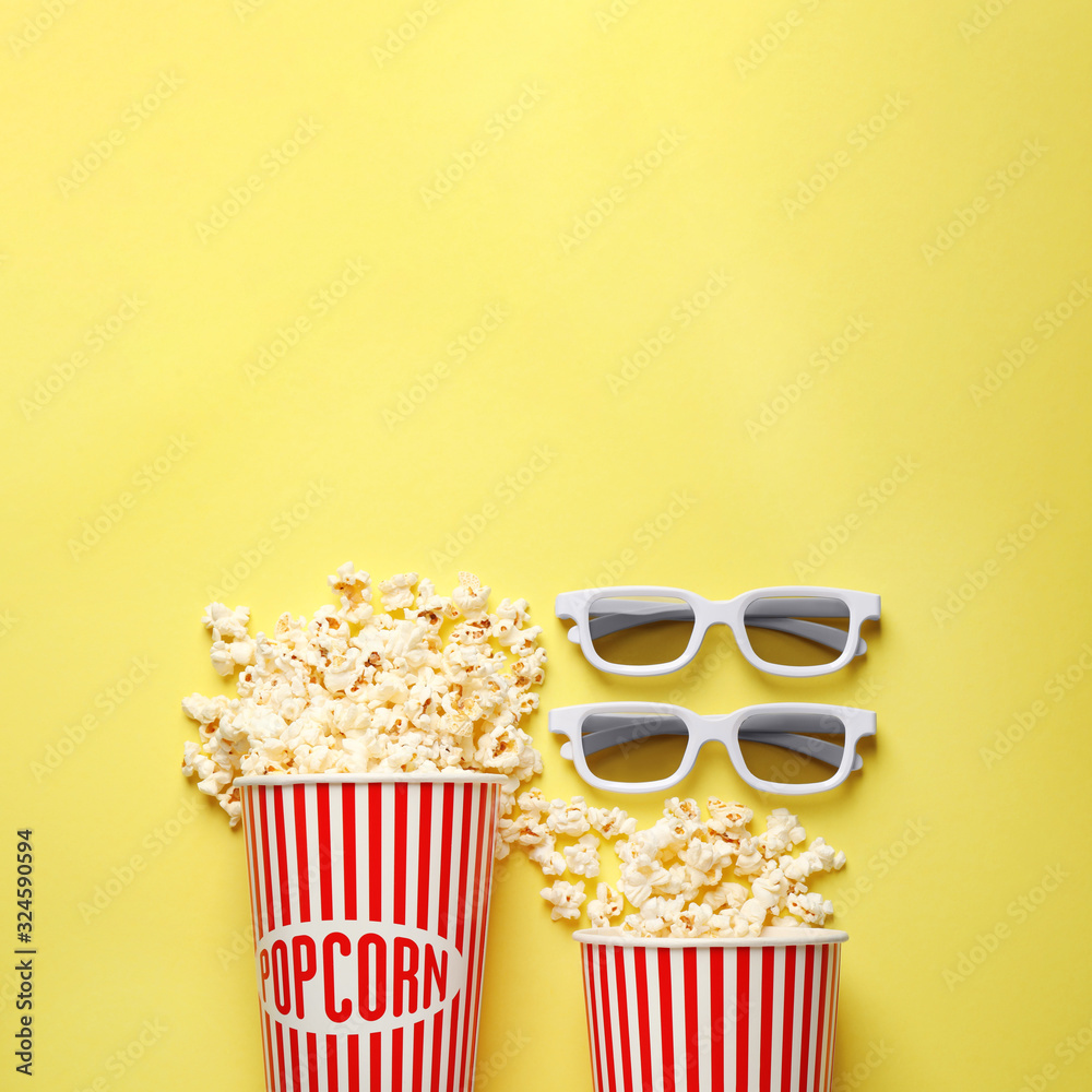 Flat lay composition with delicious popcorn on yellow background