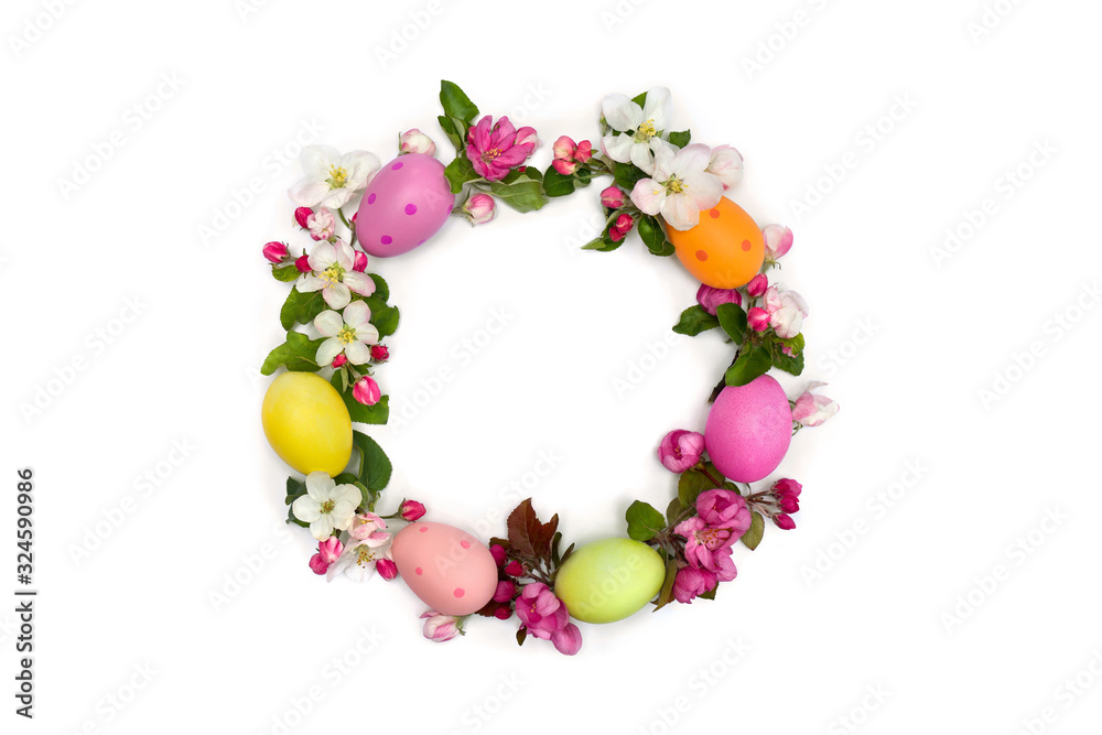 Easter decoration. Circle Easter frame of pink flowers apple tree, colored easter eggs on white background with space for text. Top view, flat lay Easter decoration. Circle Easter frame of pink flowers apple tree, colored easter eggs on white background with space for text. Top view, flat lay