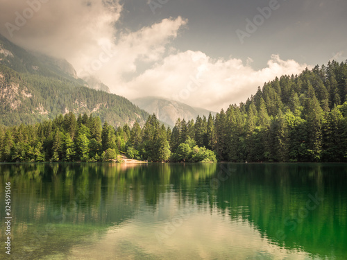 Photo of an alpine lake surrounded by mountains in summer