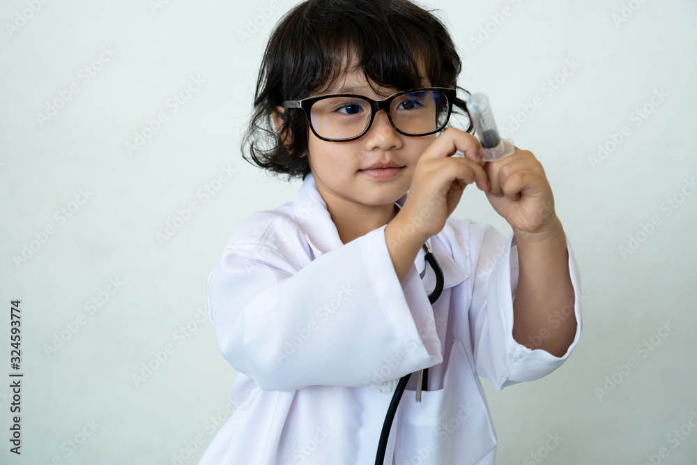 Photo of kid doctor with stethoscope and syringe on white background Photo of kid doctor with stethoscope and syringe on white background