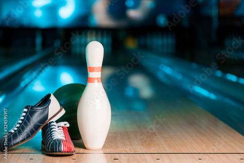 selective focus of bowling shoes, ball and skittle on bowling alley Fototapeta