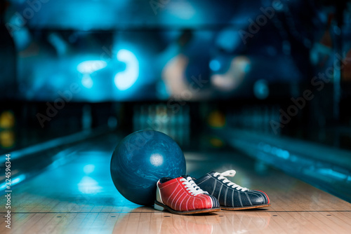 Принти на полотні selective focus of bowling shoes and ball on skittle alley in bowling club