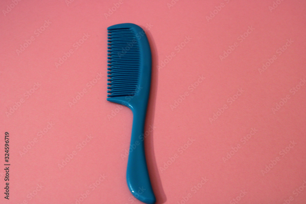small comb on a blue background small comb on a blue background